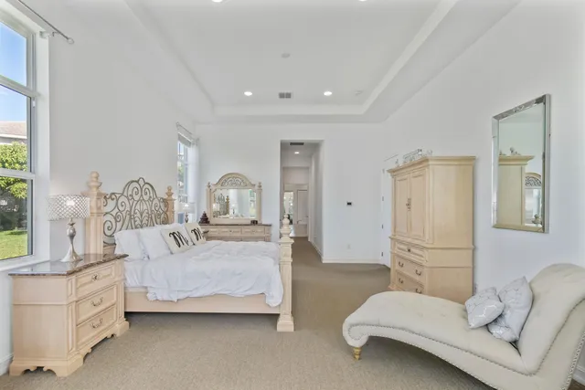 an aerial view of a house with a yard and lake view