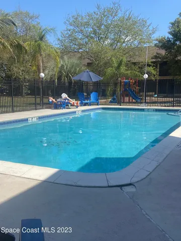 a view of a swimming pool with a table and chairs