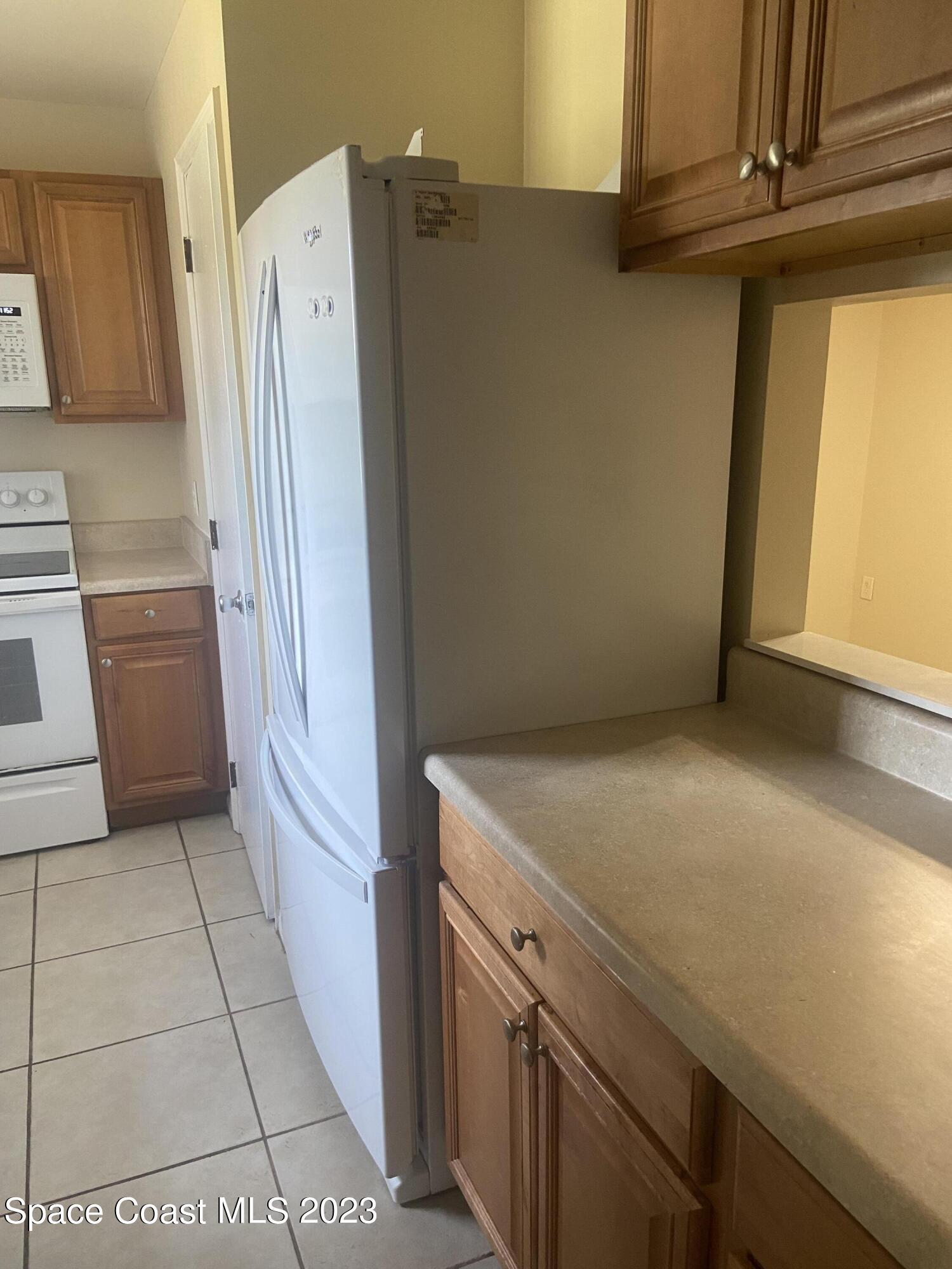 290 Spring Drive, Unit 4 Merritt Island, FL 32953 - Photo 4 of 16 a view of a storage & utility room with washer and dryer