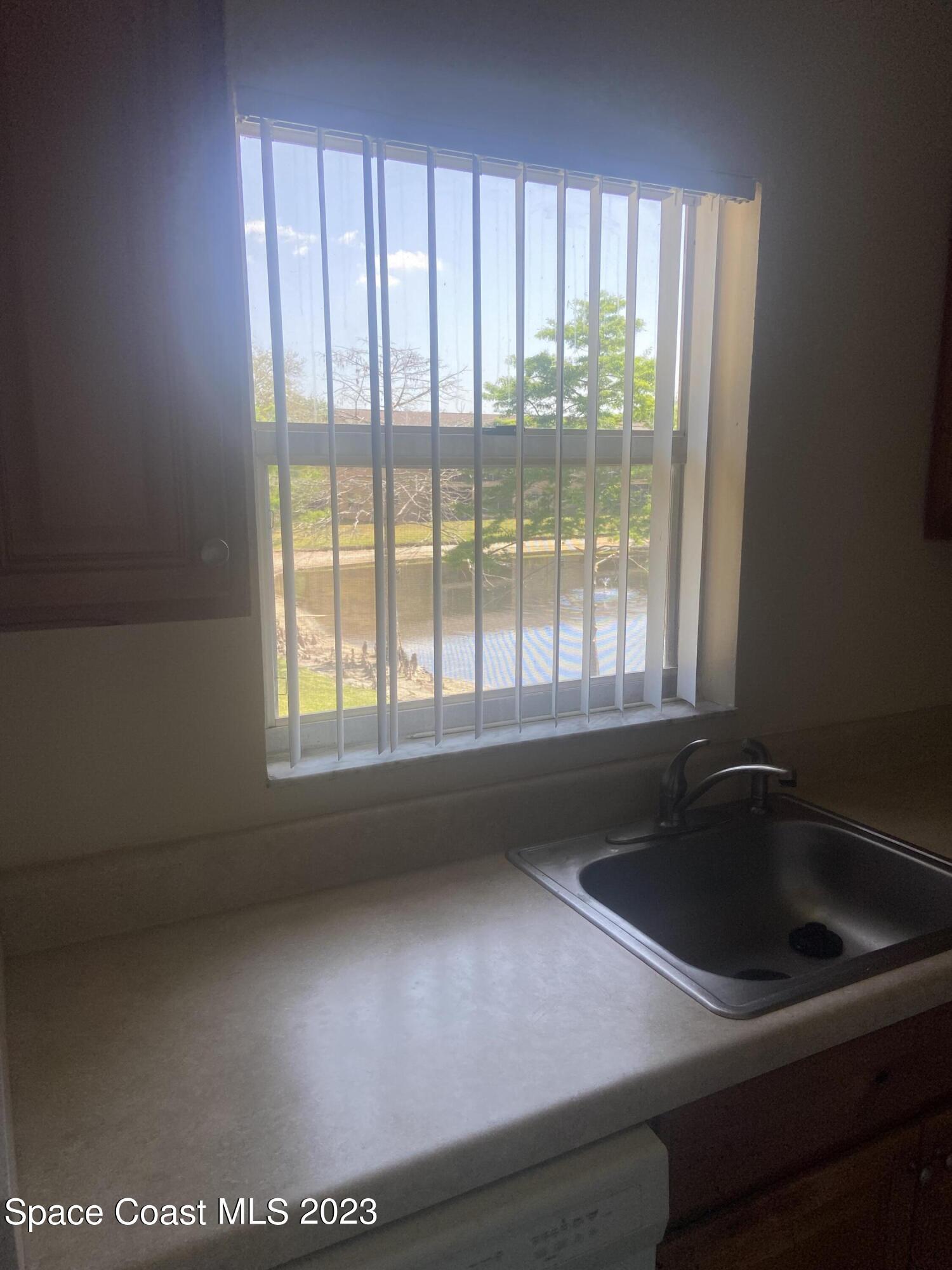 290 Spring Drive, Unit 4 Merritt Island, FL 32953 - Photo 5 of 16 a close view of sink and tap
