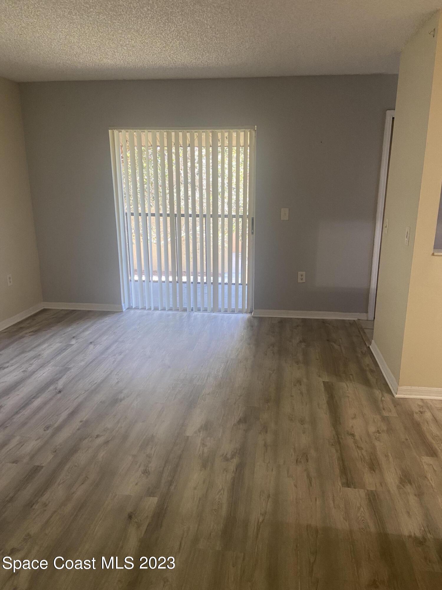 290 Spring Drive, Unit 4 Merritt Island, FL 32953 - Photo 6 of 16 a view of an empty room with a window