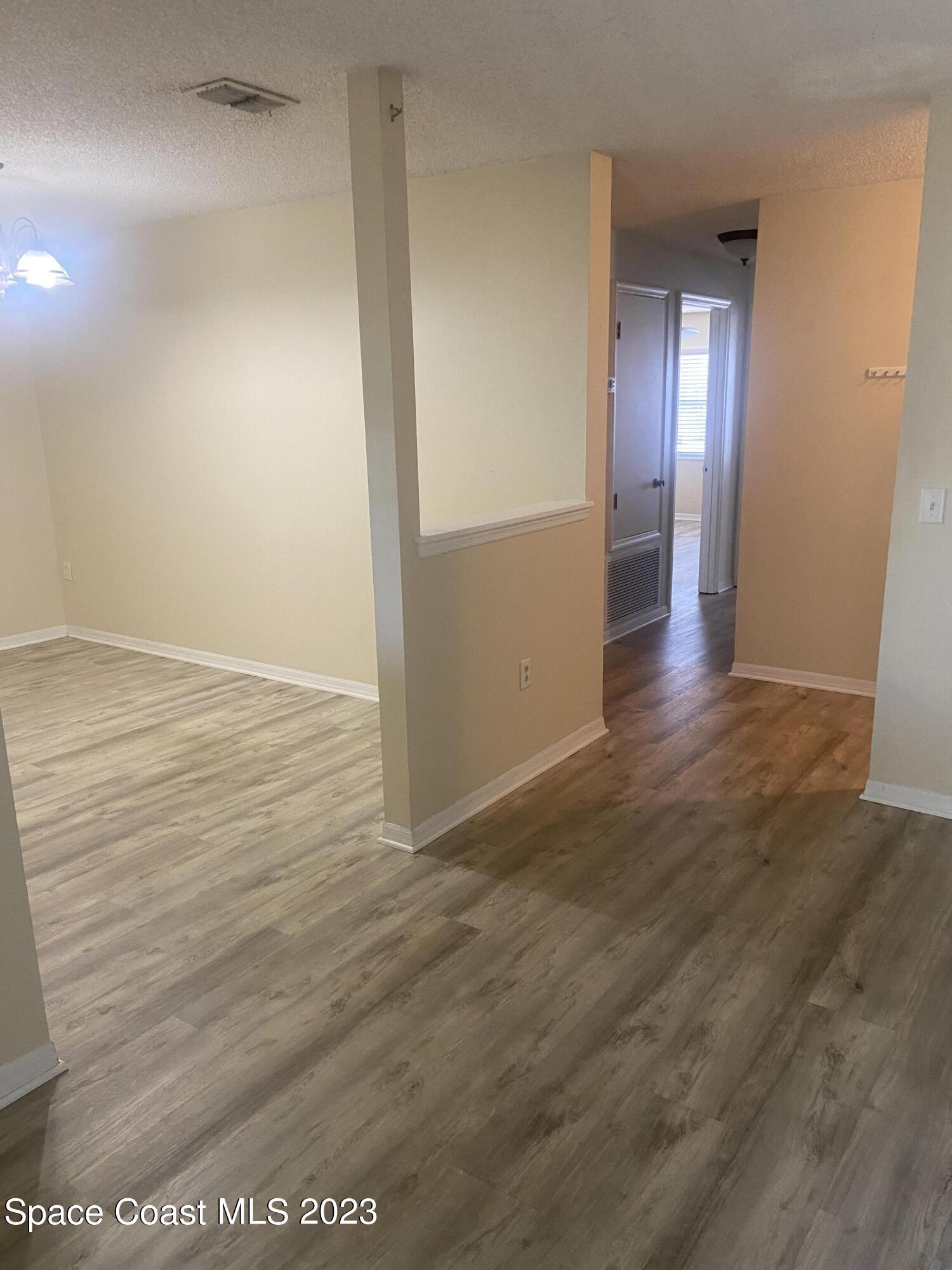 290 Spring Drive, Unit 4 Merritt Island, FL 32953 - Photo 8 of 16 wooden floor in an empty room