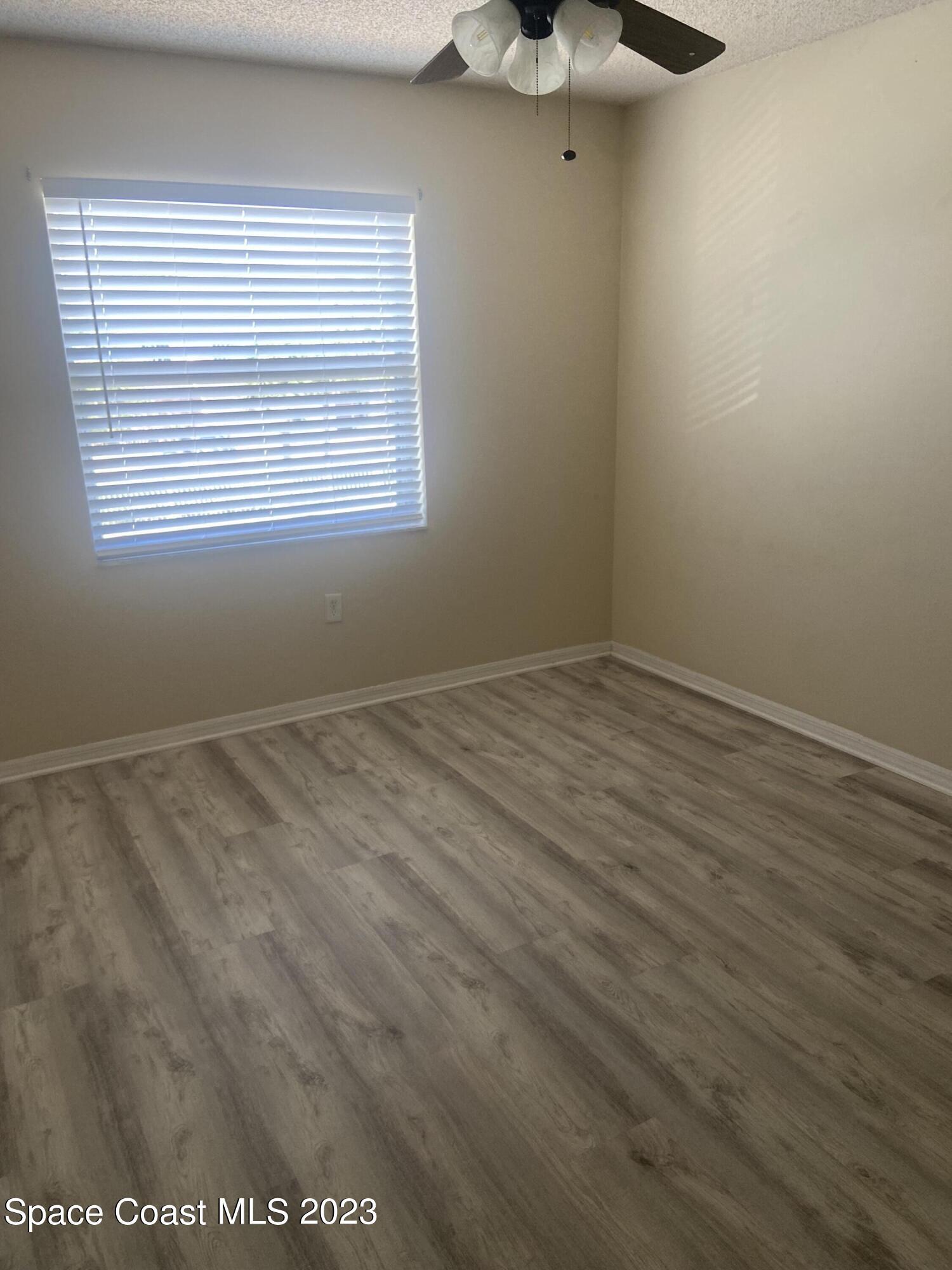 290 Spring Drive, Unit 4 Merritt Island, FL 32953 - Photo 9 of 16 a view of an empty room with a window