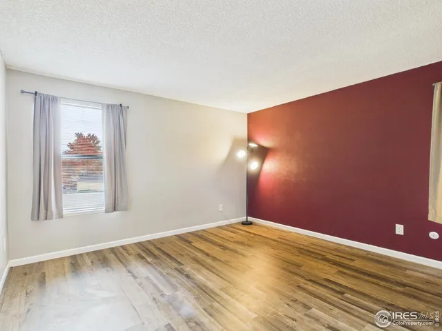 a kitchen with granite countertop a sink and white cabinets