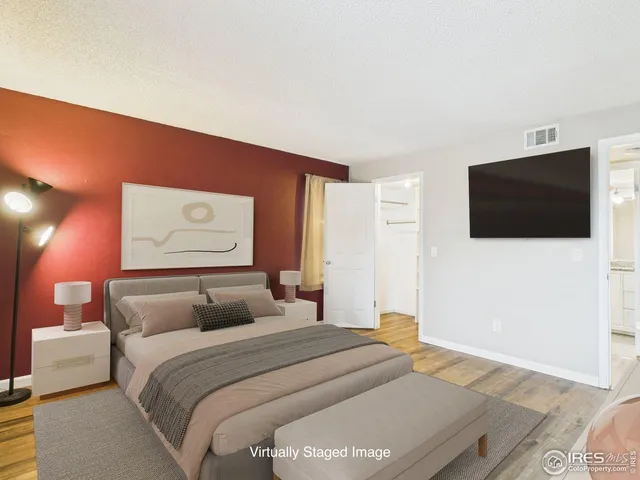 a bedroom with a bed and a potted plant