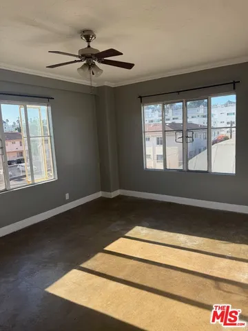 a room with a window and ceiling fan