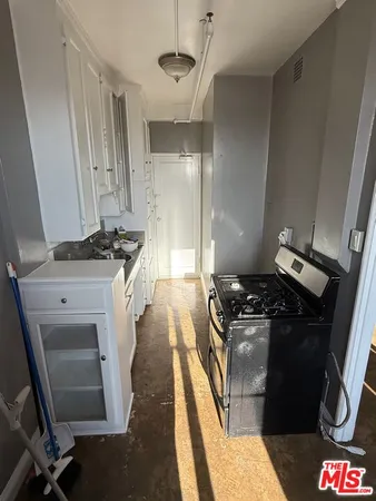 a kitchen with a stove and a refrigerator
