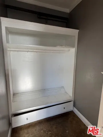 en empty room with windows and chandelier fan