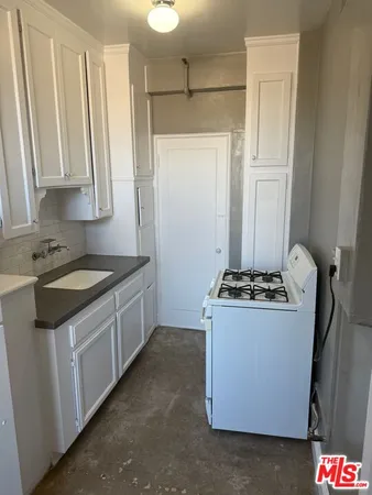 a living room with a couch and a stove next to a window