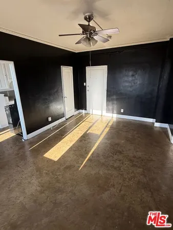 a living room with a couch and a ceiling fan