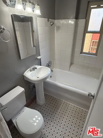 a bathroom with a toilet a sink and bathtub