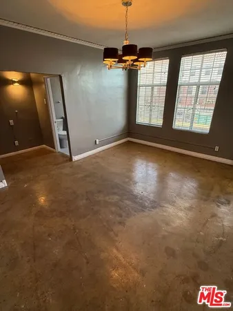 an empty room with a empty space and windows