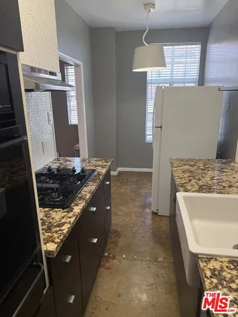 a kitchen with sink stove and cabinets