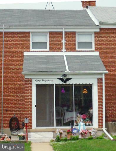 8047 Wallace Road Baltimore, MD 21222 - Photo 1 of 1 a front view of a house with garden