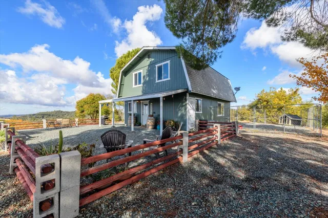 a view of a house with backyard porch and sitting area