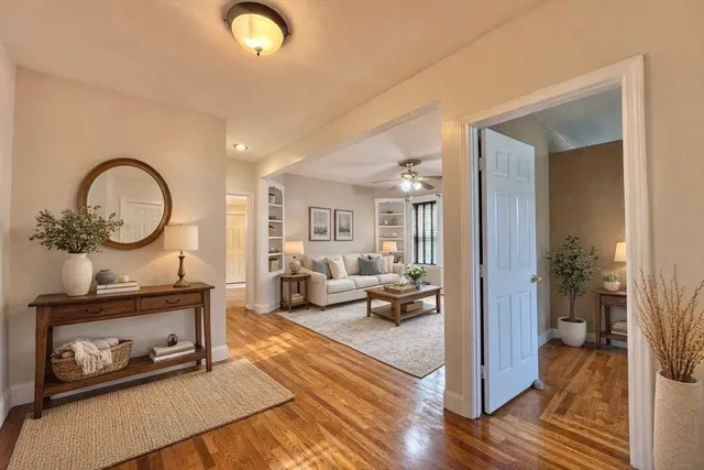 a living room with furniture a mirror and a fireplace
