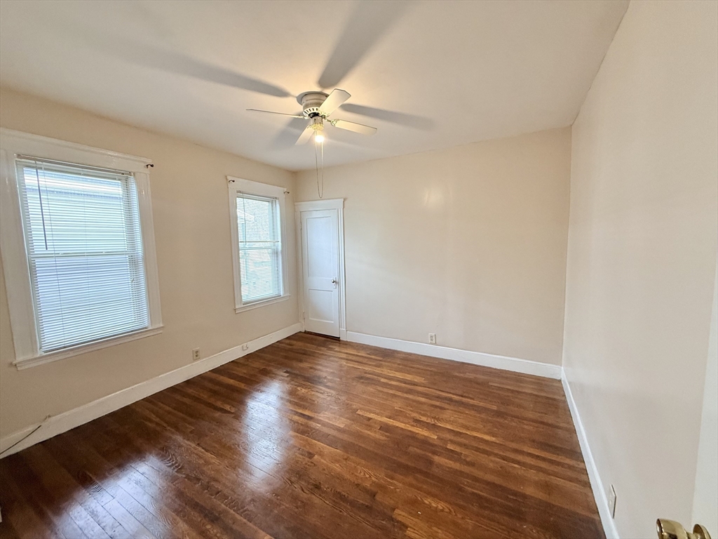 49 Favre Street, Unit 2 Boston, MA 02126 - Photo 12 of 22 a view of an empty room with wooden floor and a window