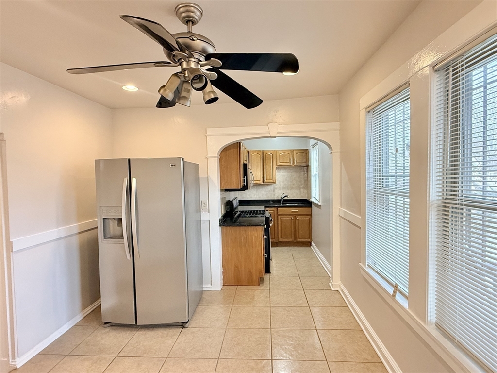 49 Favre Street, Unit 2 Boston, MA 02126 - Photo 16 of 22 a kitchen with stainless steel appliances granite countertop a refrigerator and a sink