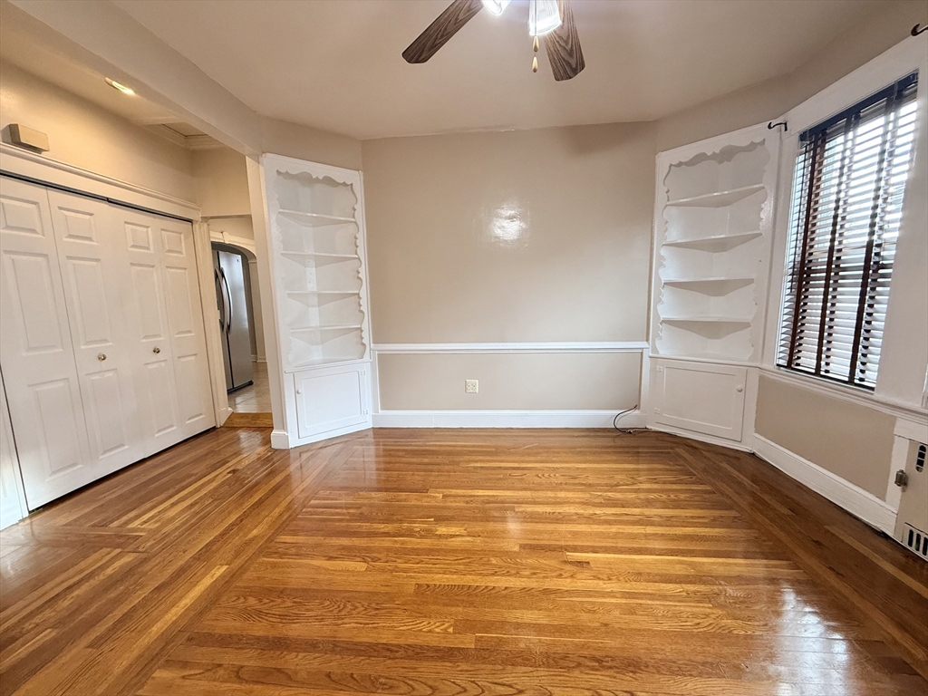 49 Favre Street, Unit 2 Boston, MA 02126 - Photo 3 of 22 a view of an empty room with window and wooden floor