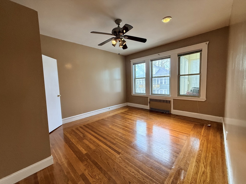 49 Favre Street, Unit 2 Boston, MA 02126 - Photo 5 of 22 wooden floor in an empty room with a window