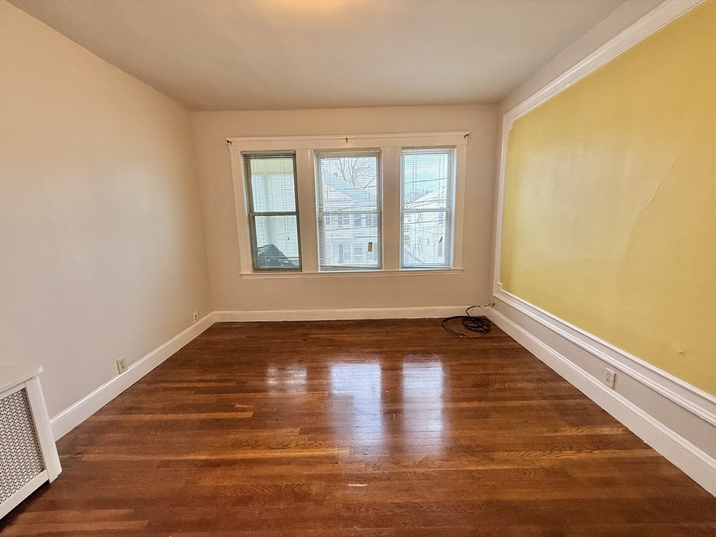 49 Favre Street, Unit 2 Boston, MA 02126 - Photo 9 of 22 a view of empty room with wooden floor and fan