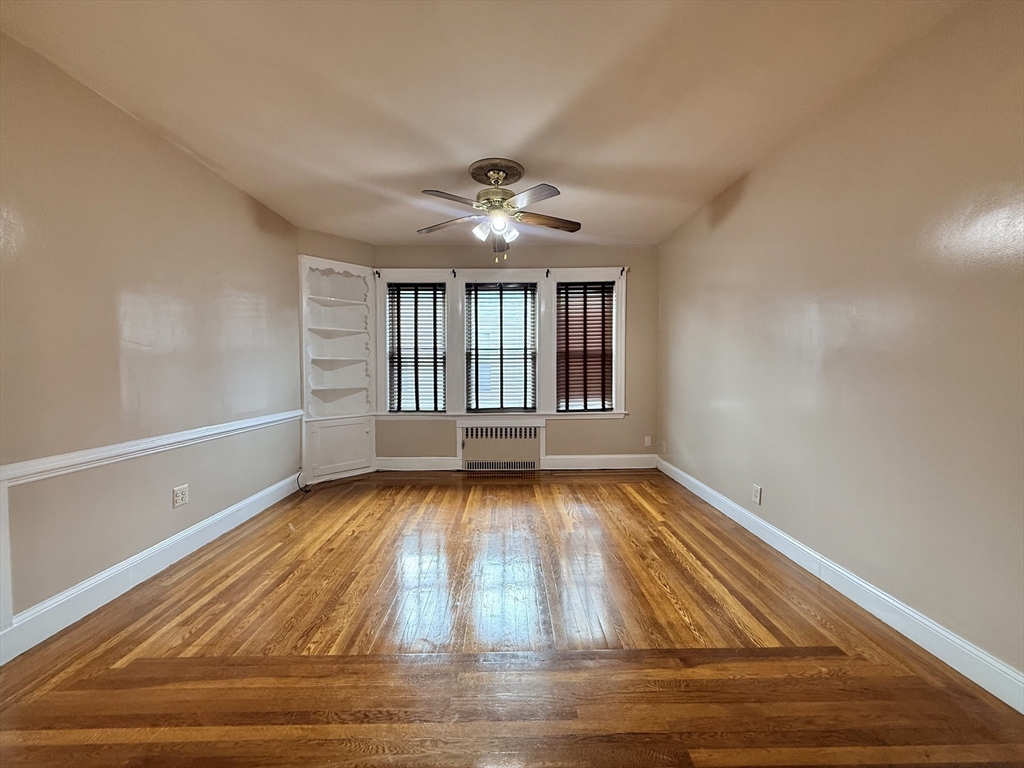 49 Favre Street, Unit 2 Boston, MA 02126 - Photo 10 of 22 wooden floor in an empty room with a window