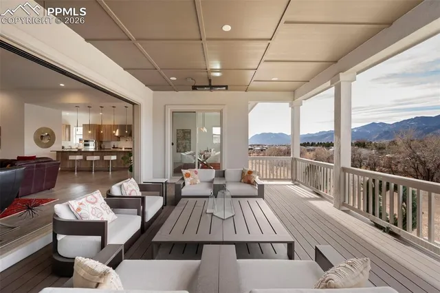 a living room with couches a dining table and chairs with outer view