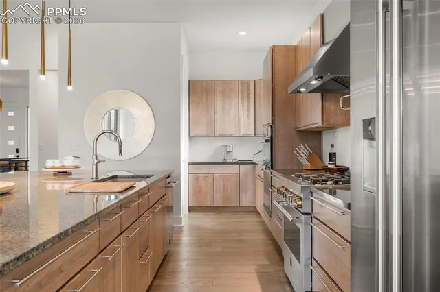 a kitchen with stainless steel appliances granite countertop a sink stove and cabinets