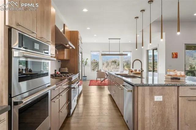 a kitchen with stainless steel appliances a sink stove and refrigerator