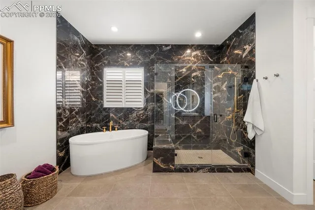 a bathroom with a tub and a shower