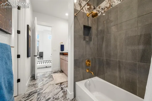 a bathroom with a bathtub and shower