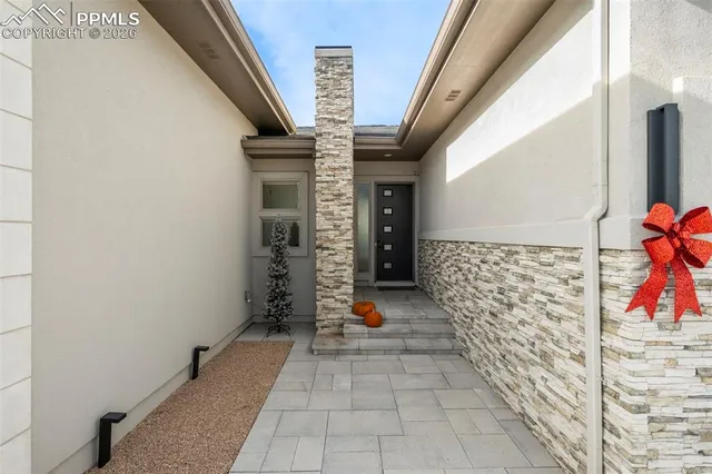 a view of an entryway with flower pots