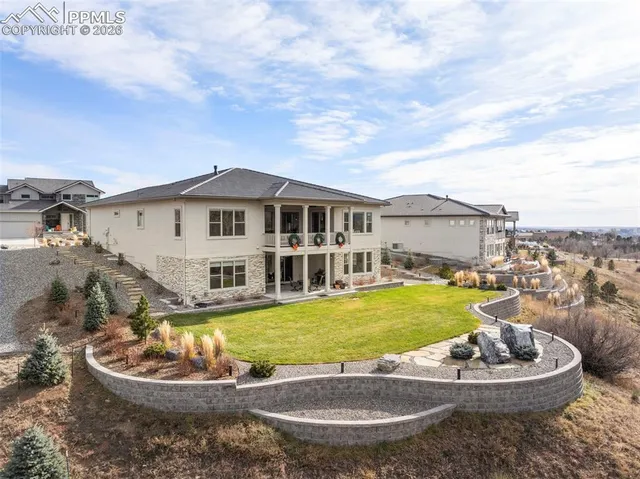 a view of a house with swimming pool and a garden