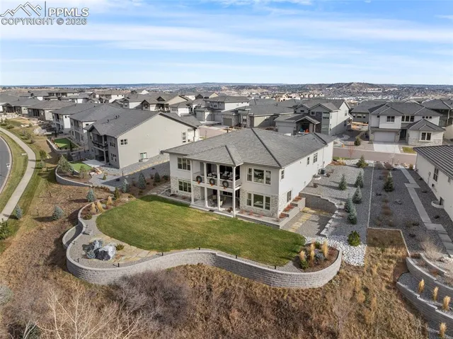 an aerial view of a house with a yard