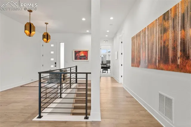 a view of entryway and hall with wooden floor