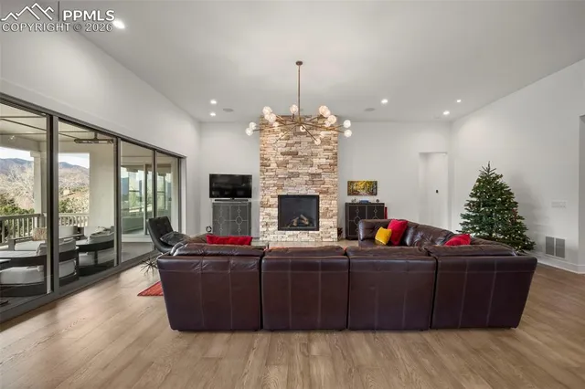 a living room with fireplace furniture and a dining table