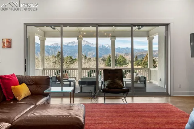 a living room with furniture and a floor to ceiling window