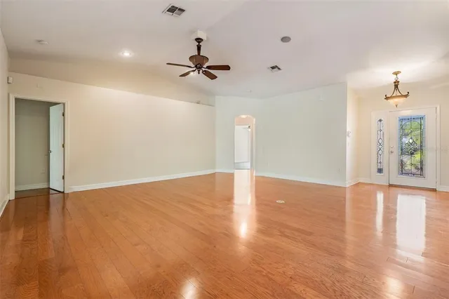 an aerial view of a house with a yard and lake view