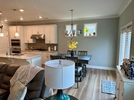 513 Forest Lane Canton, GA 30114 - Photo 20 of 54 a living room with furniture a dining table and a fireplace