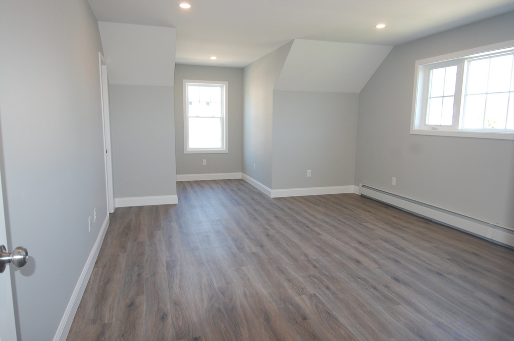 9 Bolton Road, Unit S Dartmouth, MA 02748 - Photo 12 of 19 an empty room with wooden floor and windows