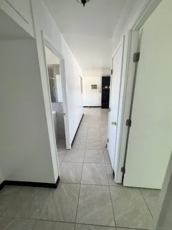 a view of a hallway to rooms and stairs