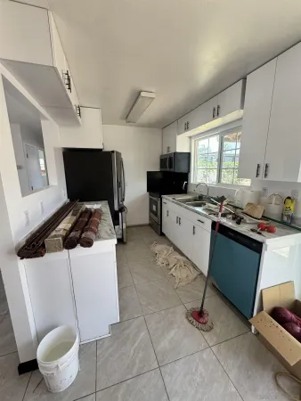 a kitchen that has a sink and a stove top oven