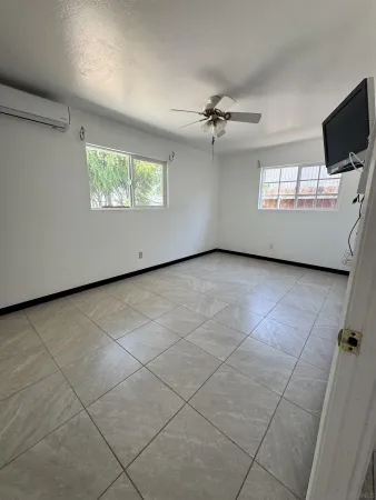 a view of a livingroom with furniture and a ceiling fan