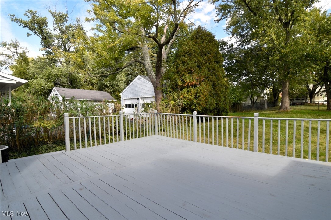 1443 Churchill Road Lyndhurst, OH 44124 - Photo 37 of 39 Wooden deck featuring a detached garage, view of wooded area, and an outdoor structure