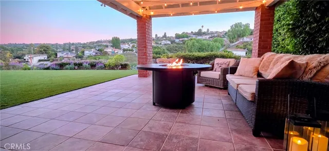 a view of a patio with a table chairs and a fire pit