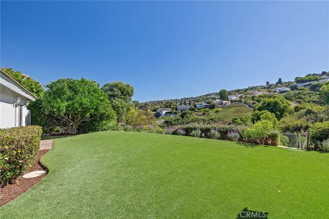a spacious bedroom with a bed a couch and a window