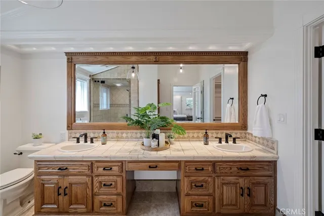 a hallway with white cabinets and wooden floor