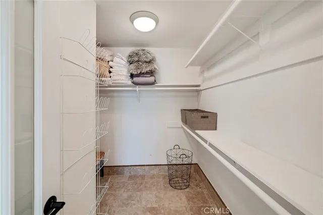 a kitchen with granite countertop a sink stainless steel appliances and white cabinets