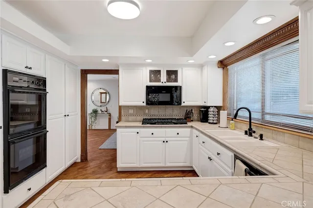 a living room with furniture potted plant and a large window