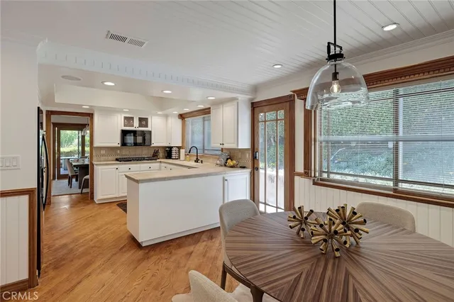 a kitchen with cabinets and wooden floor